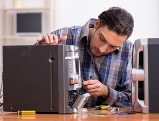 Young engineer repairing musical hi-fi system