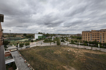 Panoramic views of a residential development with vacant lots on a rain cloud laden winter day