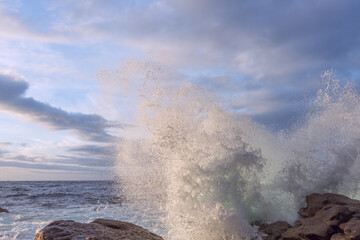 Sea waves hitting rocks on the Galician coast at sunset