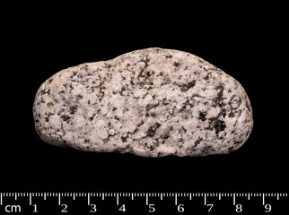 Igneous rock macro shot isolated on black background 