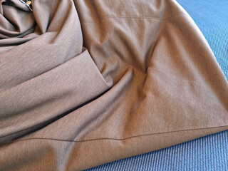
A crumpled piece of brown cloth. - obrazy, fototapety, plakaty