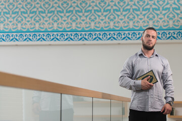 Portrait of a Muslim Man Holding Book Koran