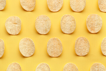 Fototapeta na wymiar Many delicious potato chips on yellow background