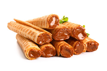 Stack of delicious wafer rolls with boiled condensed milk and mint isolated on white background