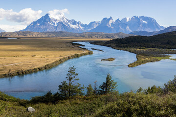Fototapeta na wymiar Serrano River, golden pampas and snowy mountains of Torres del Paine National Park in Chile, Patagonia, South America