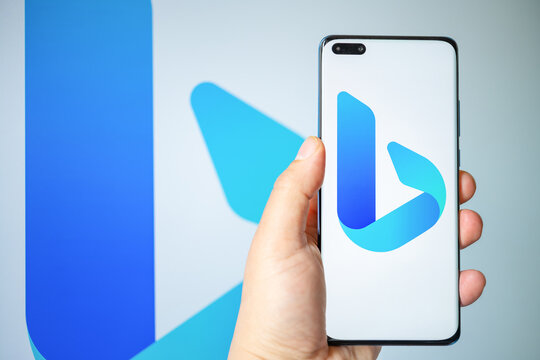 ZhongShan China-March 5,2023:man holding a mobile with a big new Bing logo at horizontal composition.