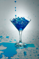 Splashing in style- a blue colored drink in a conical glass with a splash stand