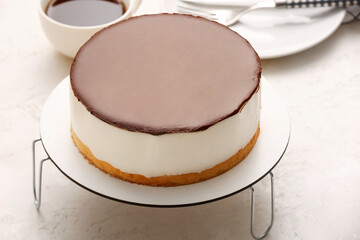 Dessert stand with delicious birds milk cake on light background, closeup