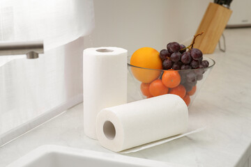 Rolls of paper towels on white countertop in kitchen