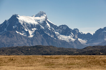Fototapeta na wymiar Golden Pampas and snowy mountains of Torres del Paine National Park in Chile, Patagonia, South America