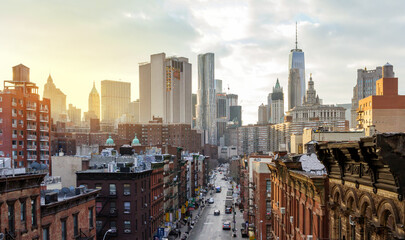 Overhead view of Madison Street in the Chinatown neighborhood of Manhattan with the downtown skyline buildings of New York City in background - obrazy, fototapety, plakaty