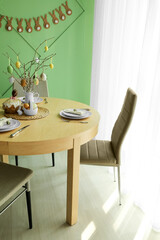 Interior of dining room with table served for Easter celebration