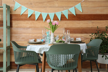 Interior of dining room with table served for Easter celebration