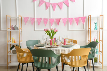 Interior of dining room with table served for Easter celebration