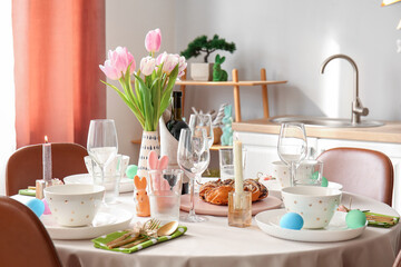 Interior of kitchen with festive table served for Easter celebration