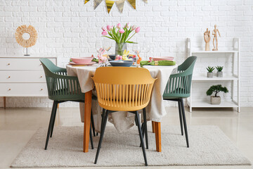 Interior of dining room with table served for Easter celebration