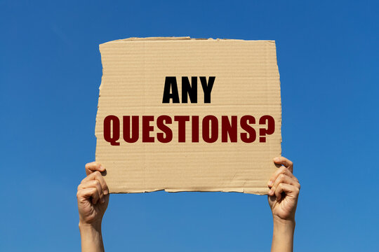 any questions text on box paper held by 2 hands with isolated blue sky background. This message board can be used as business concept to ask audience any questions.
