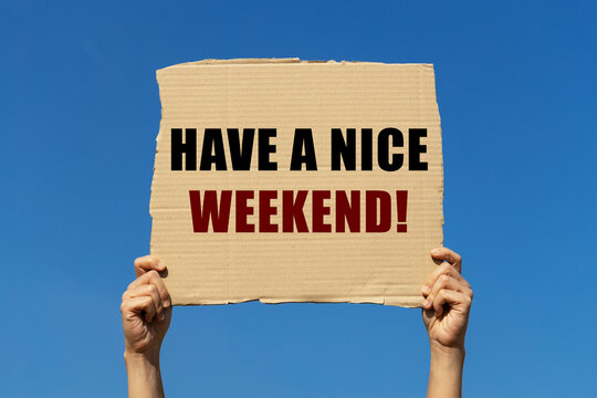 Have a nice weeked text on box paper held by 2 hands with isolated blue sky background. This message board can be used as business concept to inform audience to have a nice weekend.