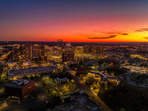 Colorful red, orange, yellow sunset sky over Reston town business center in Virginia