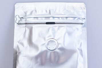 A zip lock coffee bag with degassing valve. A valve allows carbon dioxide to escape without letting...