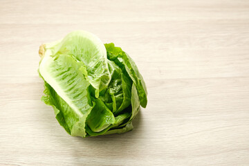 Fresh green romaine lettuce on a wooden background
