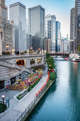 View of Chicago, Illinois and Chicago River with buildings and bridges at dusk