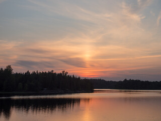 Fototapeta na wymiar setting sun over the forest lake
