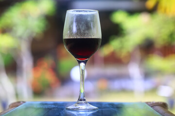 a glass of red wine in a luxurious background restaurant