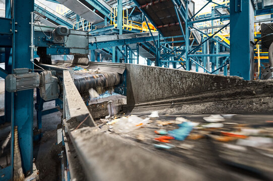 Conveyor carries trash pieces in recycling plant workshop