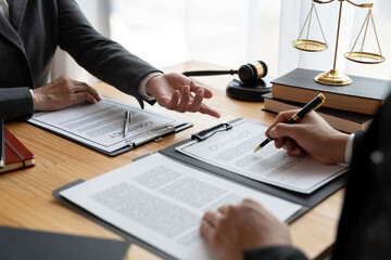 Lawyers, lawyers, Asian businessmen are working together to clarify. Review and review business contracts or life insurance contracts for benefits or sign documents and get a loan start a business.
