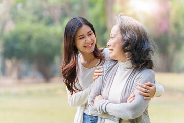 Portrait of an adult daughter with her elderly mother with hug and happy moment