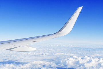 Wing aircraft in altitude during flight. clear sky in sunny day. travel concept
