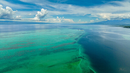 Aerial view of Manjuyod sandbar in the turquoise water of the sea on the atoll. Negros, Philippines.