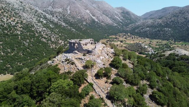 Turkish castle ruins in the Leuka Ori mountains aerial view reversing Improu gorge in the Askifou plateau, Crete