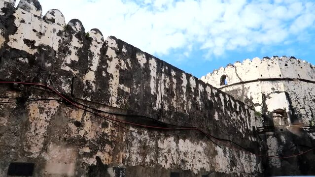 Exterior wall with battlements and small tower of old fort of Zanzibar, Stone Town