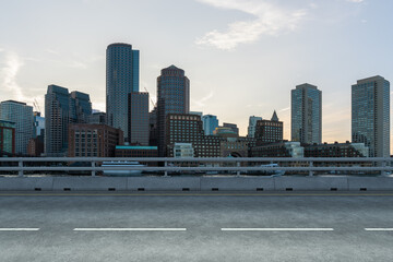 Fototapeta na wymiar Empty urban asphalt road exterior with city buildings background. New modern highway concrete construction. Concept of way to success. Transportation logistic industry fast delivery. Boston. USA.