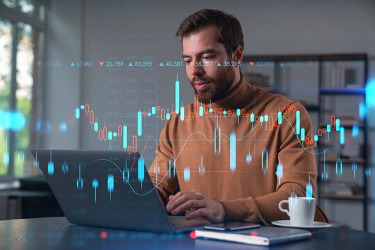 Thoughtful businessman trader in casual wear looking at charts and graphs at laptop at office workplace. Concept distant trading work, business education, analysis, technology. Forex chart and graph - Powered by Adobe