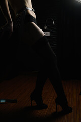 Silhouette of sexy woman legs in dark
