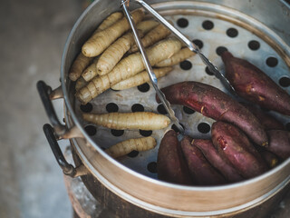 Steamed potato. Top view of steaming potato & arrowroot on the steamer. Vintage filter applied. Arrowroot is known by many names such as Maranta arundinacea, West Indian arrowroot & Bermuda arrowroot