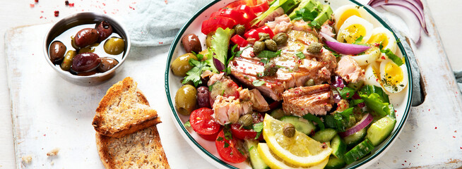 Tuna salad with lettuce, eggs and tomatoes.