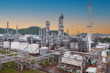 The oil refinery plant form industry zone ,which the factory - petrochemical plant, Shot from drone of Oil refinery with sunset sky scene