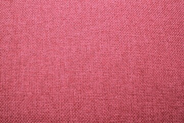 Abstract design background of pink coarse-grained intersection texture of rough fabric with an interlacing. Linen sack textile canvas burlap cloth. Close-up, mock up, top view