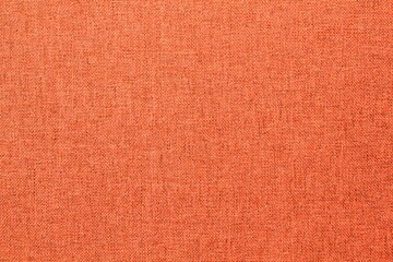 Abstract design background of dark orange coarse-grained intersection texture of rough fabric with an interlacing. Linen sack textile canvas burlap cloth. Close-up, mock up, top view