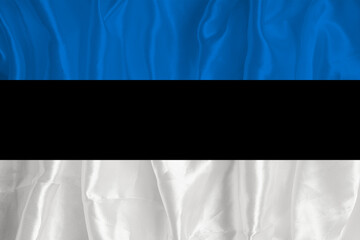 The flag of Estonia on a silk background is a great national symbol. Fabric texture The official state symbol of the country.