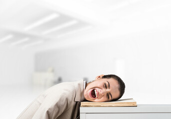 Bored business woman lying on desk