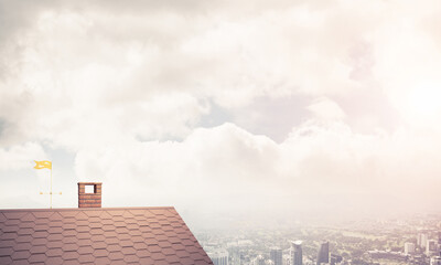Brick house roof and modern cityscape at background