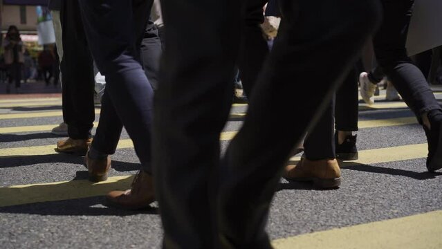 Crowd of people crossing the road during rush hour at Central District in Hong Kong, Slow Motion