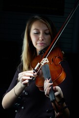Pretty young woman laying on violin