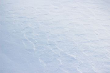 Background in the form of a snow-covered earth's surface on a winter day