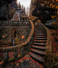 Hresko, Czech Republic - Lovely curvy stone steps and stone cottage in the Czech woods near Hresko at autumn with colorful fall leaves and foliage